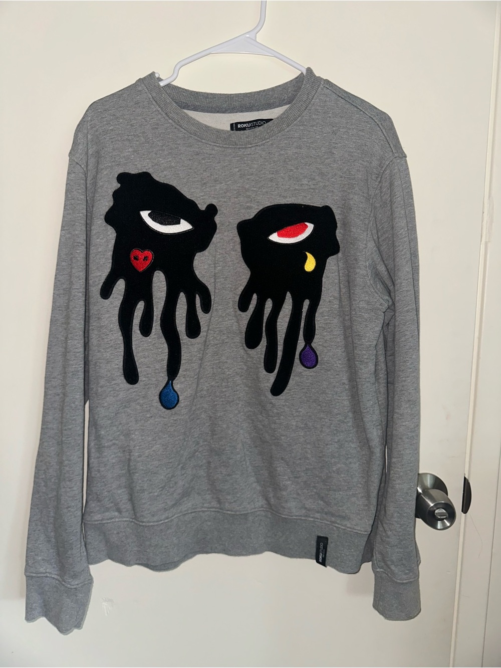 Roku Studio Gray Graphic Crewneck Sweater with Multicolor Dripping-Eye Motif